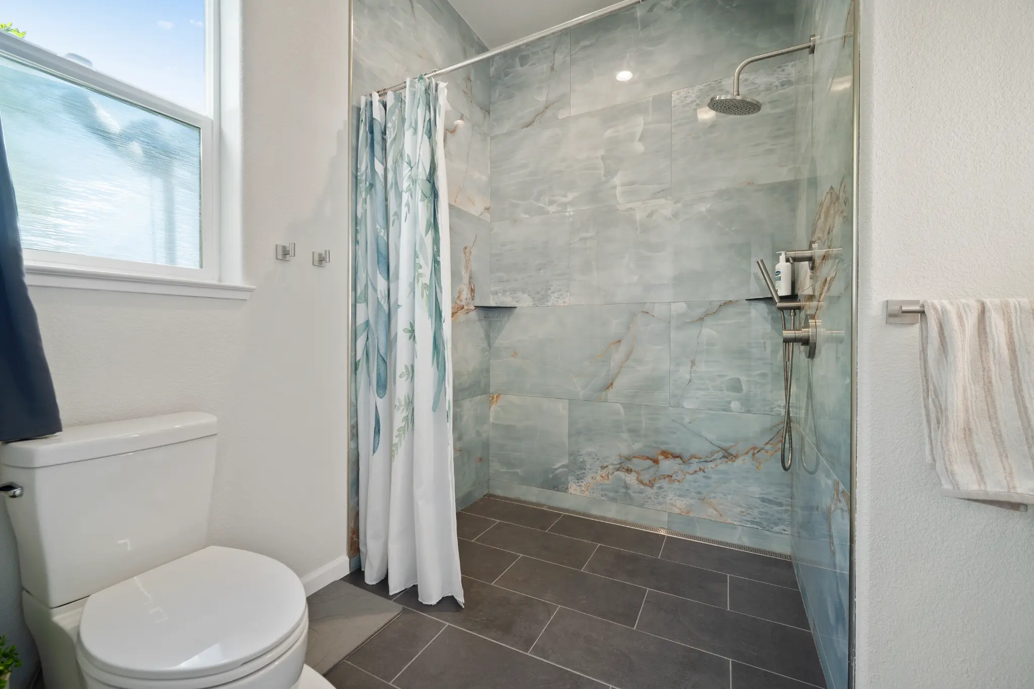 Bathroom renovation with navy blue vanity and white quartz countertop at Seven Pines Court home in Virginia Foothills South Reno NV