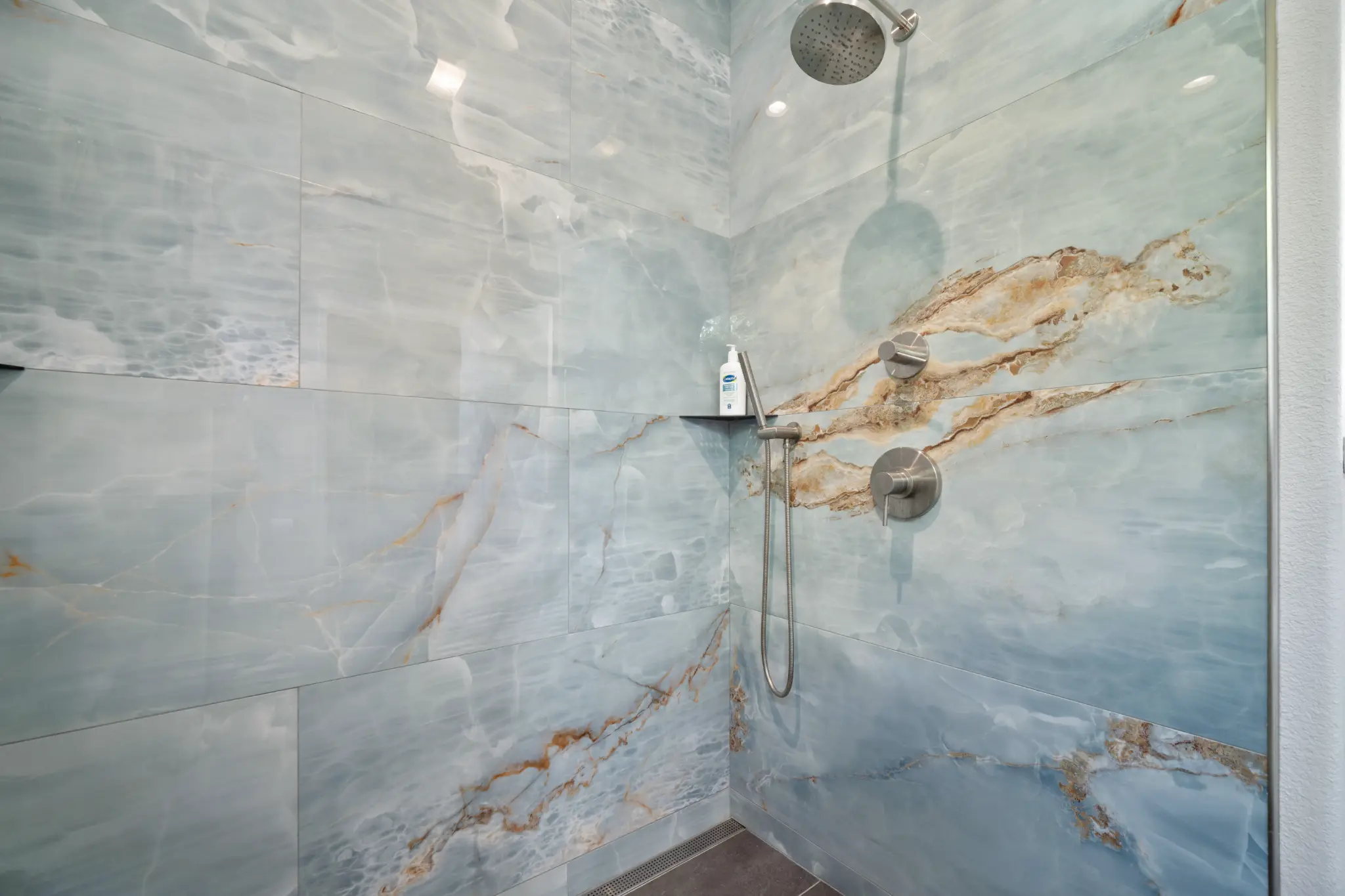 Bathroom detail with contemporary fixtures and tile work at Seven Pines Court mountain home Damonte Ranch Reno 89521