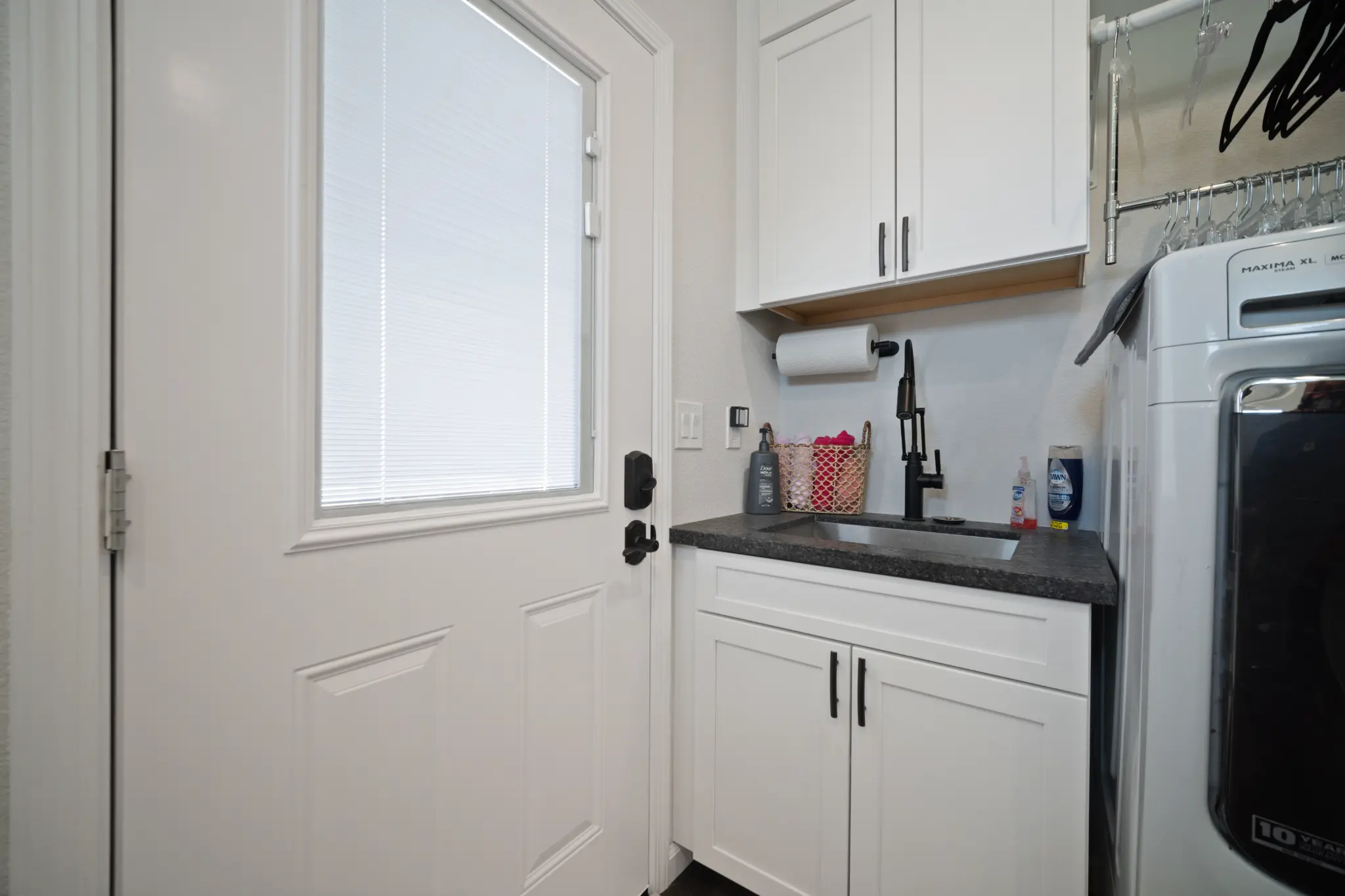 Utility room with laundry sink and black faucet at Seven Pines Court mountain home in Virginia Foothills Reno Nevada