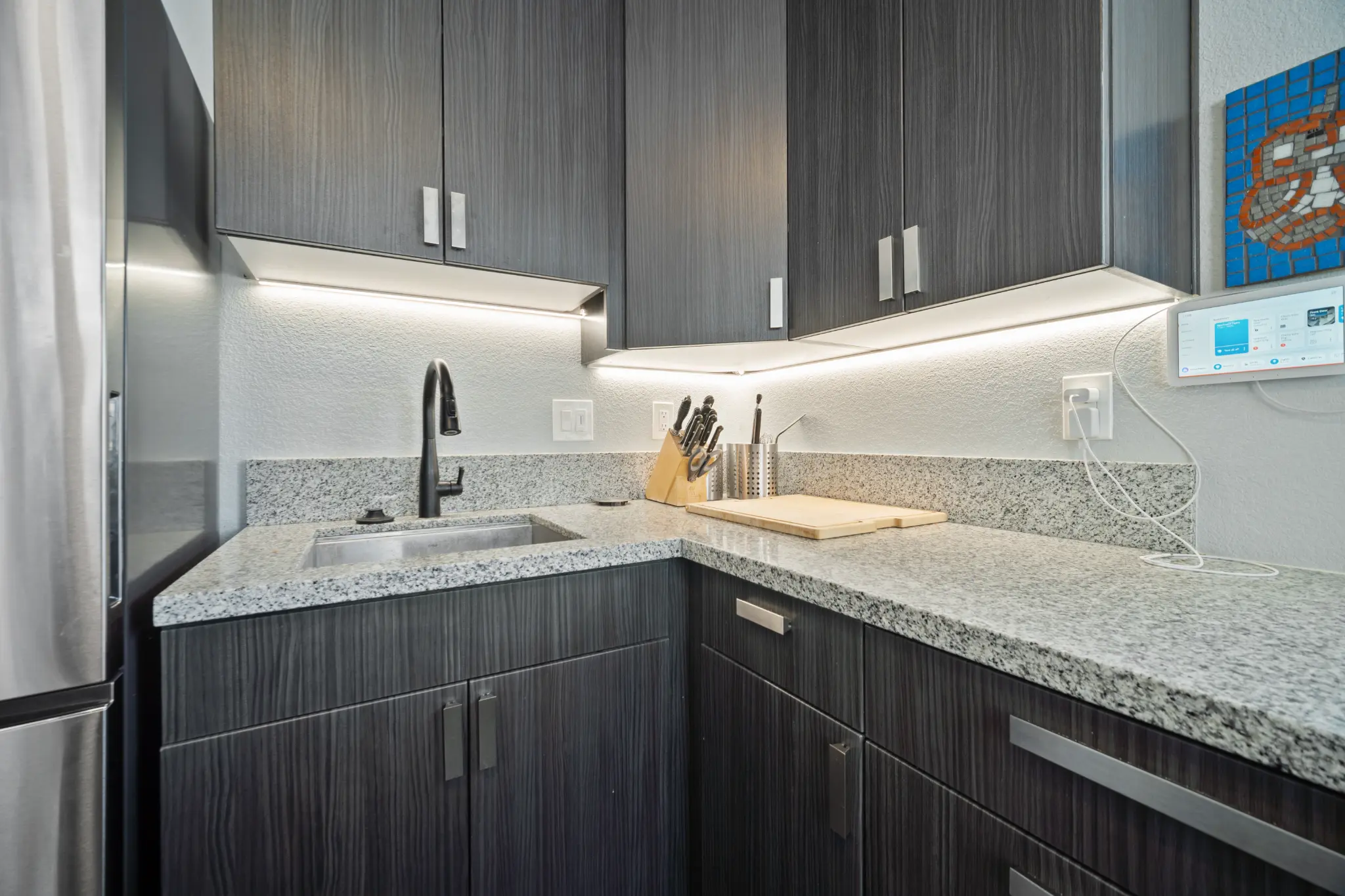 Kitchen detail showing under-cabinet LED lighting and granite countertops at Seven Pines Court home in South Reno Nevada