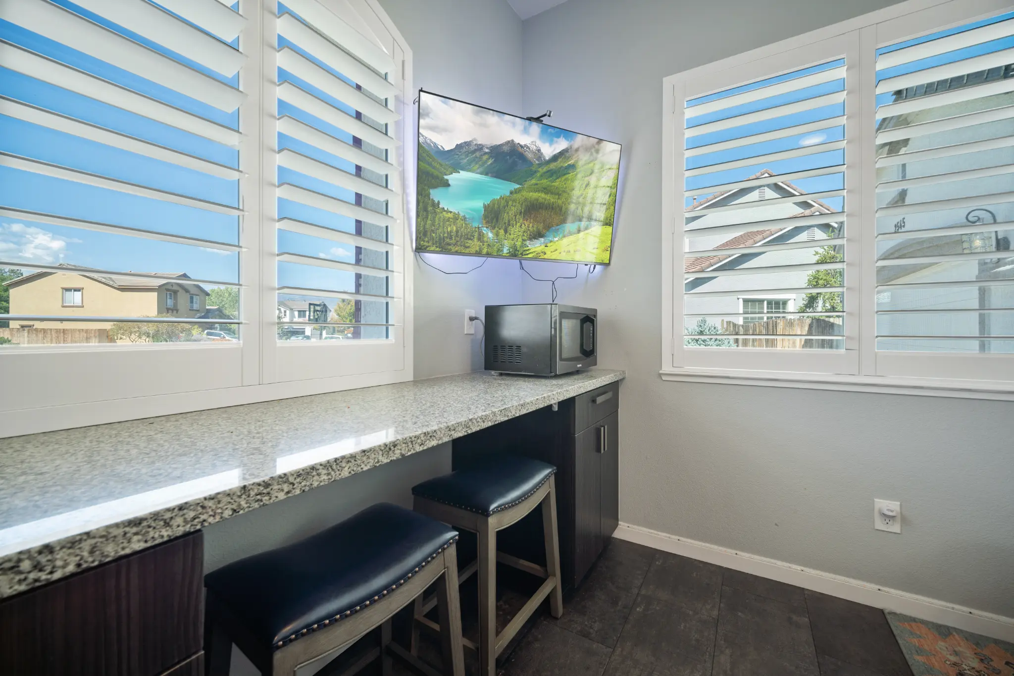 Breakfast bar and sitting area with plantation shutters at Seven Pines Court home remodel in Damonte Ranch Reno NV