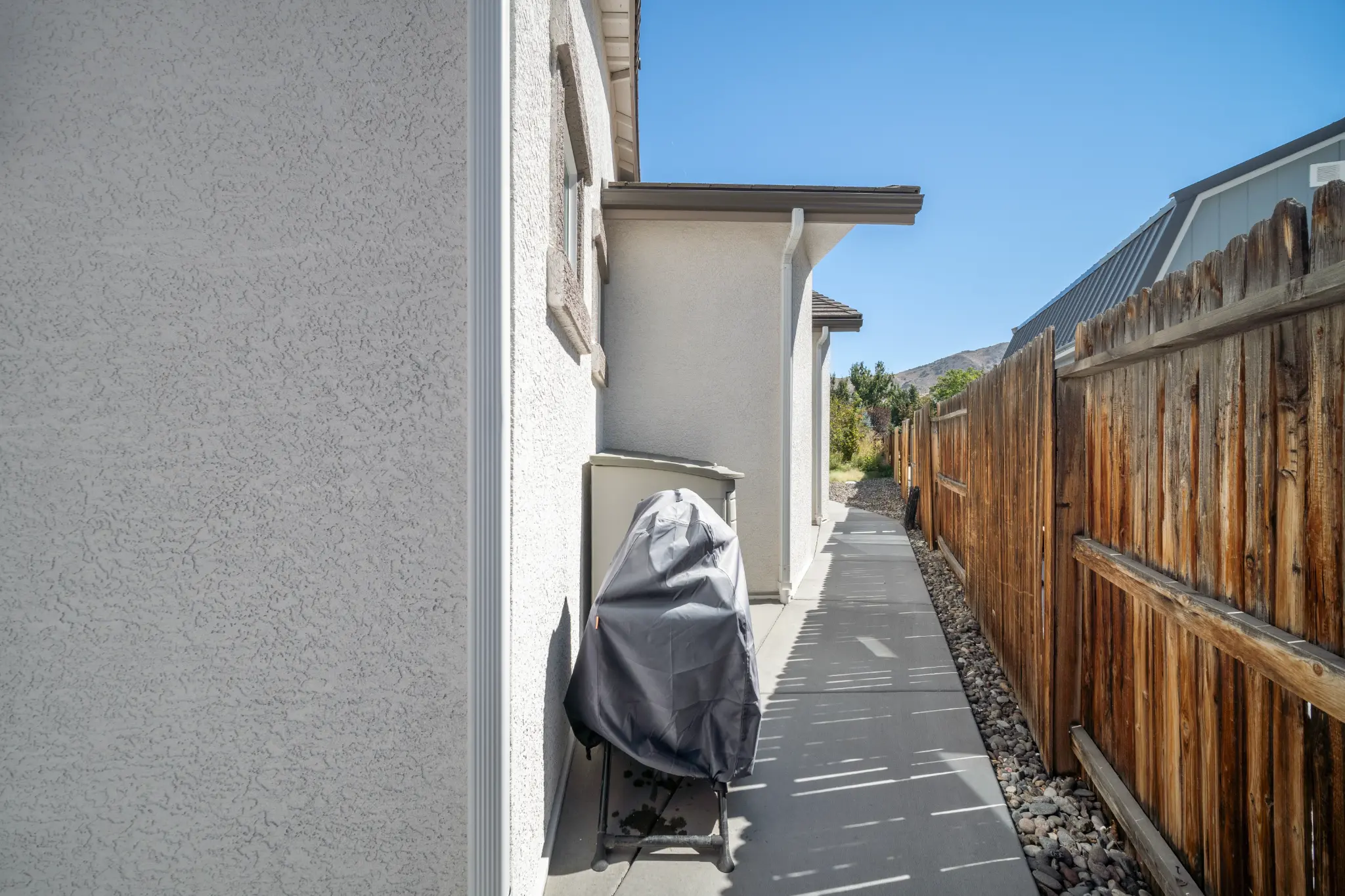 Rear exterior of Seven Pines Court luxury home with covered deck in Damonte Ranch area South Reno